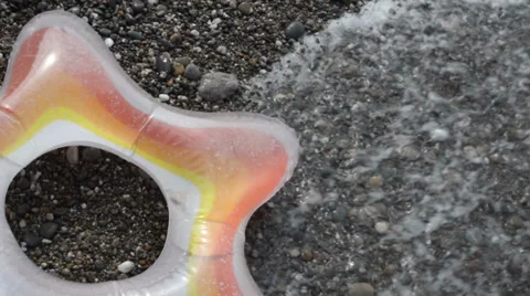 Swimming ring on the pebble beach Video stock 36757172