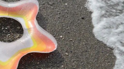 Swimming ring on the pebble beach Stock Footage 36757525