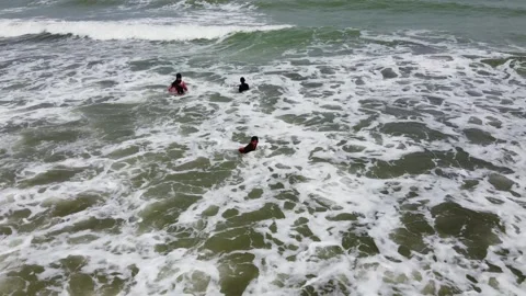 Swimming with rolling waves, aerial view. taken by drone Stock Footage 147674151