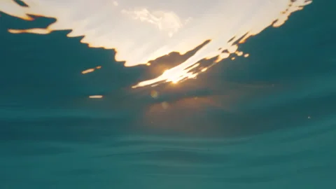 Swimming at sea during sunset, paragliding in the sky, half camera underwat.. Stock Footage 335242574