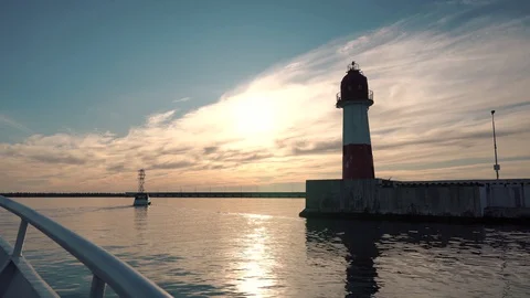 Swimming on a ship at the lighthouse. Beautiful view of the lighthouse. The Stock Footage 129745792