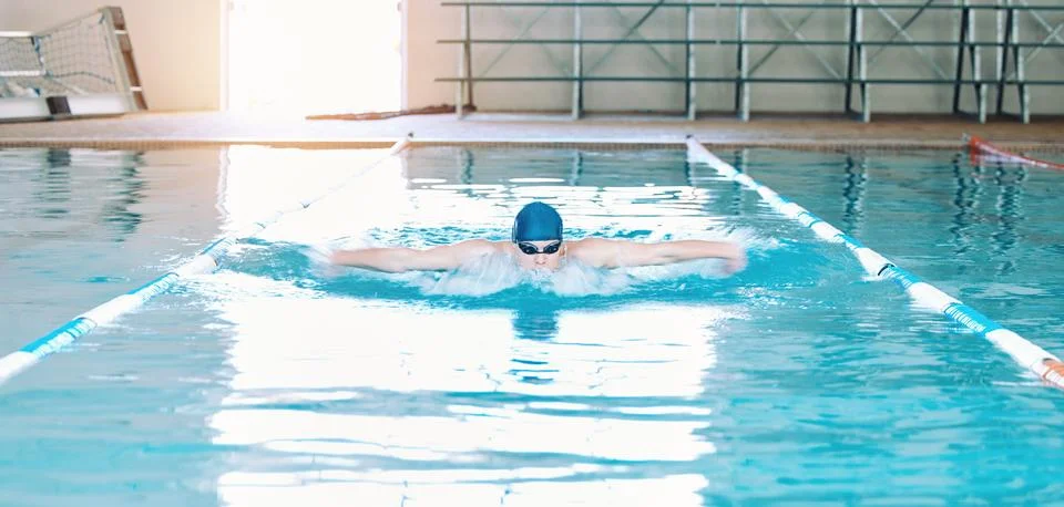 Swimming, sports and man in pool at gym for training, competition and exercise Stock Photos