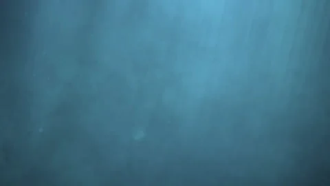 Swimming Through Sunlight Rays in Deep Blue Ocean Stock-Footage 303557712