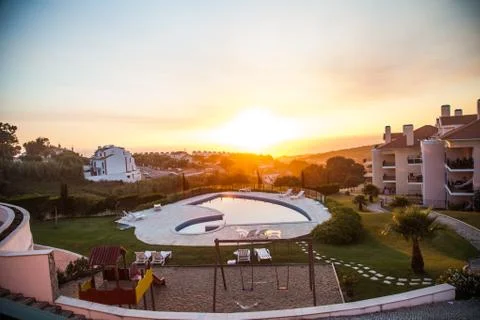 Swimmingpool and sunset Stock Photos