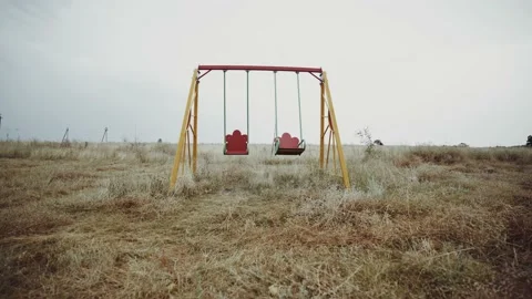 Swing in an abandoned place. An empty playground in the middle of a wasteland. 動画素材 149240724