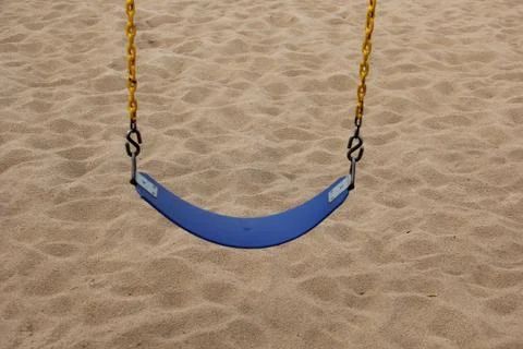 A swing above the sand of a beach Stock Photos