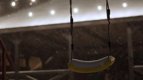 Swing against the background of a snow-covered roof with decorative lighting  Stock-Footage 148243609