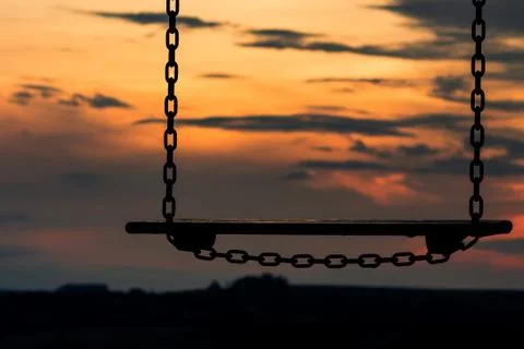 Swing and sunset Stock Photos