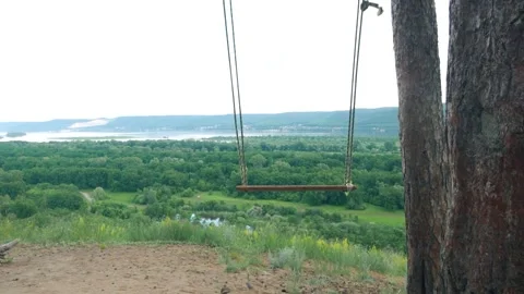 Swing on the background of a beautiful landscape Stock Footage 260554811