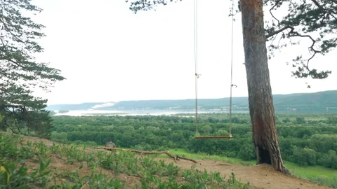 Swing on the background of a beautiful landscape. Summer time Stock Footage 260704236