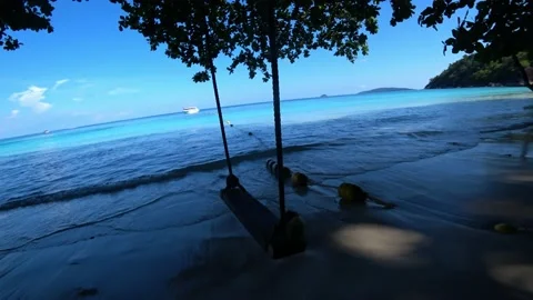 Swing on the beach with ocean view and boat. Stock Footage 190098511