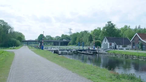 Swing bridge opening over a rural canal in the netherlands 스톡 동영상 336845359