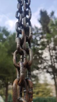 Swing chain in the park. Close-up macro photo. Integration, teamwork metaphor. Stock Photos