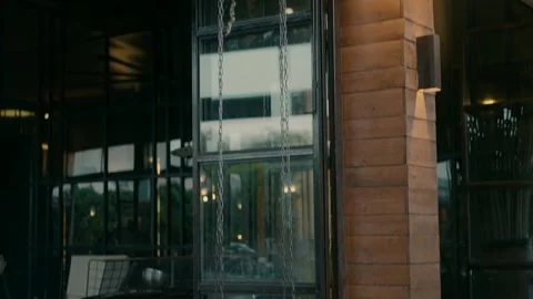 Swing on the chains at the entrance to the building. Video stock 239159000
