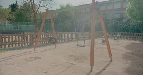 Swing closed with warning tape in children's playground in public park of Stock Footage 132070160