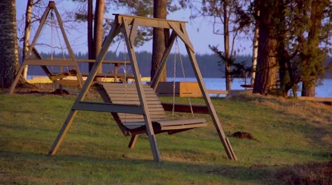 Swing on the coast of lake. Sunset Video stock 67532994