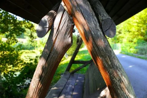 Swing with a cobweb in the evening light. Ancient wooden swing with a spider Stock Photos