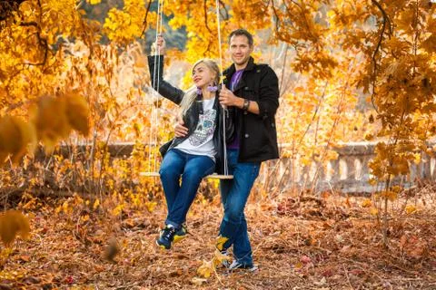 On swing is couple Stock Photos