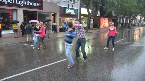 Swing dancing in the rain in the streets barefoot. Stock Footage 40336458