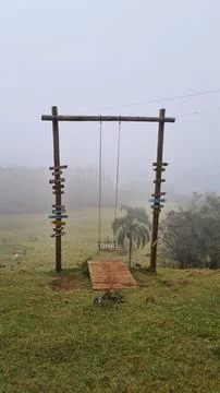 Swing on the edge of the hill Stock Photos