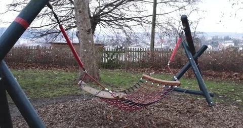 Swing in empty playground covered Stock Footage 145225100