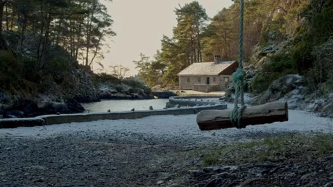 A swing in the foreground with a nice snowy background. sunset Stock Footage 233898274