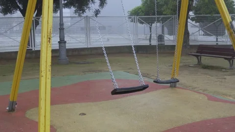 A swing in motion, in a children's park Stock Footage 303841389
