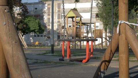 Swing in an open-air playground closed due to the Covid-19 Corona virus. Stock Footage 128933499