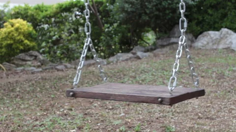 A swing in the park rocks without anyone on it Stock Footage 131518321