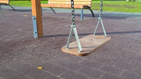 Swing in a park setting, captured with a smooth dolly movement, showcasing the Stock Footage 320874407