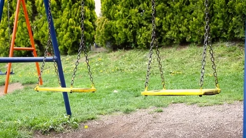 Swing on the playground moves in the wind Stock-Footage 75271971