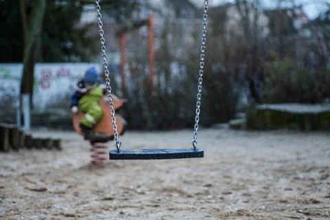 A swing at a playground Stock Photos
