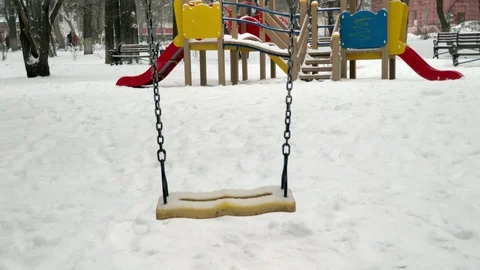 Swing on the playground in the snow without people Stock Footage 129521852