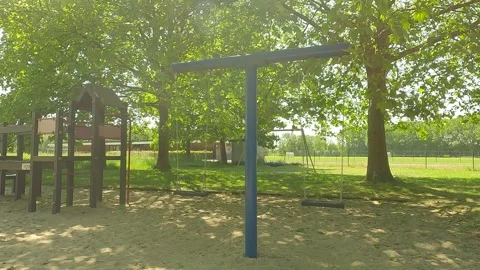 A swing in a playground with trees. Stock Footage 244582683
