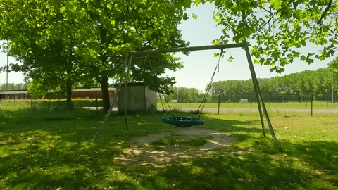 A swing in a playground with trees. Stock Footage 244582697