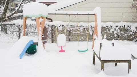 Swing set in a backyard in a snow storm Stock Footage 104530439
