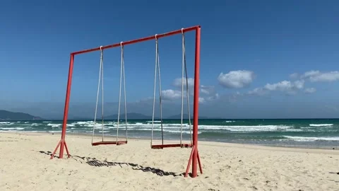 Swing standing on the shore of a sandy tropical beach Stock Footage 123369926