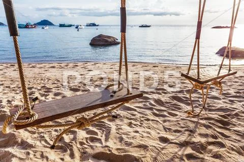 Swing on sunset at the beach Stock Photos