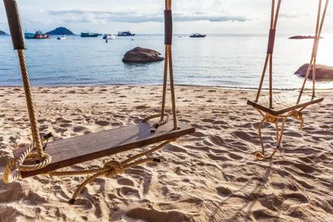 Swing on  sunset at the beach Stock Photos