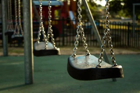Swing suspended on chains in the playground Stock Photos