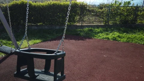 Swing swing empty in a playground Stock Footage 182976167