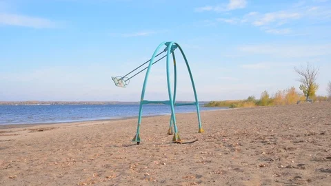 Swing swing on an empty sandy beach on a sunny day Stock Footage 118505722