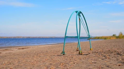 Swing swing on an empty sandy beach on a sunny day Stock Footage 118505740