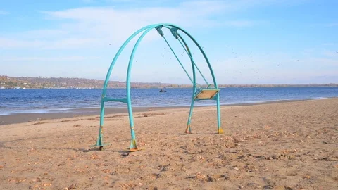 Swing swing on an empty sandy beach on a sunny day 動画素材 118505742