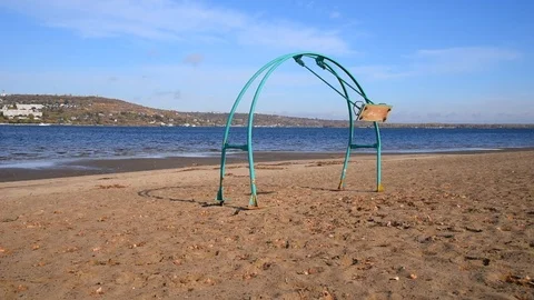 Swing swing on an empty sandy beach on a sunny day Stock Footage 118505748
