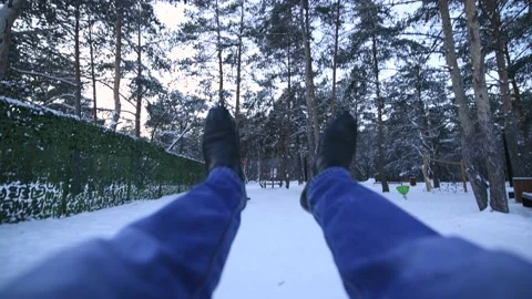 Swing on a swing first person view, close-up of men's legs in the winter forest Stock Footage 146302000