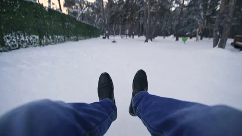 Swing on a swing first person view, close-up of men's legs in the winter forest Stock Footage 146503920