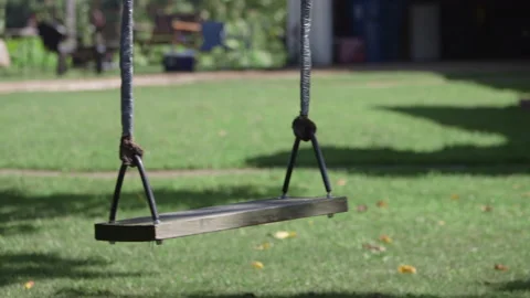 Swing swinging with noone on it child abduction Video stock 137620249
