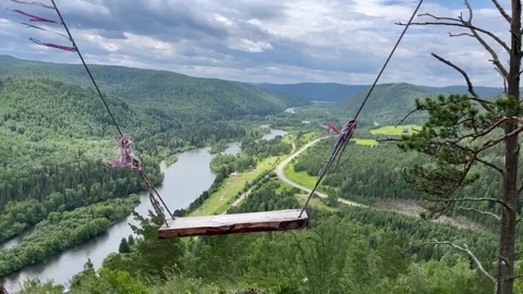 Swing, teetering-board over a cliff in the mountains. Stock-Footage 246370880