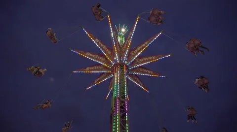Swing tower ride at amusement park on a cloudy early evening. 4K UHD. Stock Footage 54315280